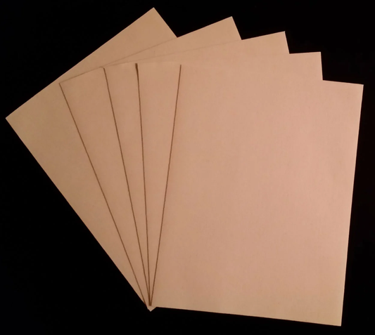 Five sheets of tan fine art canvas paper fanned out against a black background