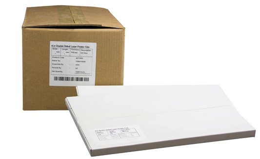 Carton of double sided laser printer film beside a wrapped pack of transparency film sheets